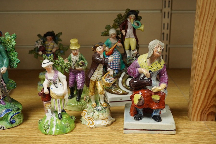 A group of nine Staffordshire pearlware figures and figure groups to include Scuffle and Dolly Pentreath, a dandy etc., largest 20cm high. Condition - some restoration